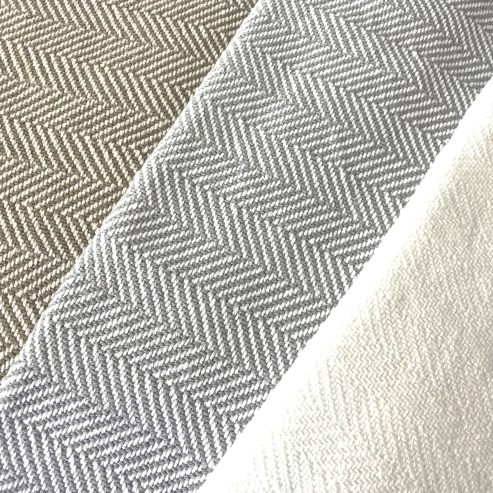 American Blanket Company - 100% Cotton Bed Blanket, Feather Weave Pattern cotton Blanket - Fan out of the various blanket colors showing white, gray and white, and khaki and white in a lovely herringbone