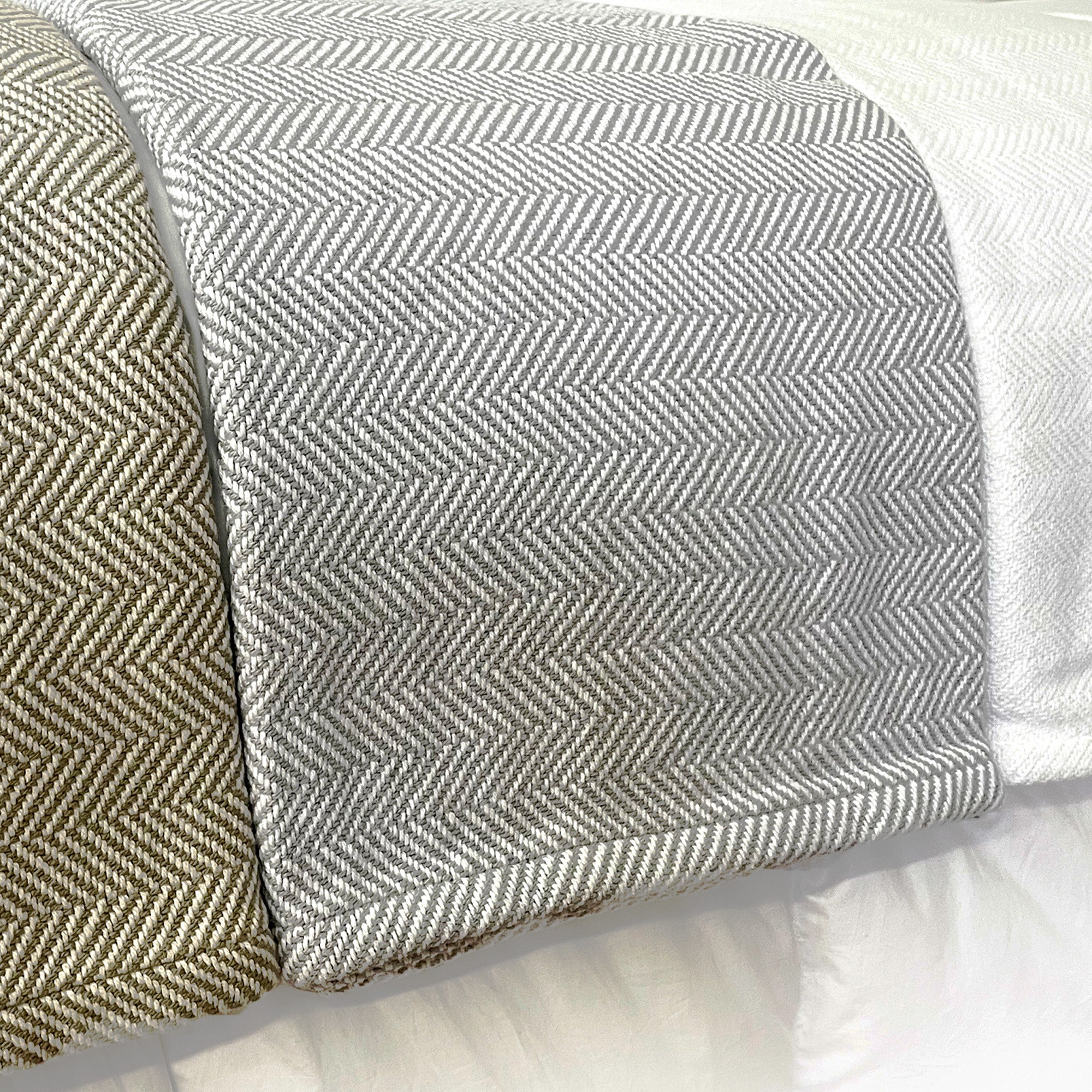 American Blanket Company - 100% Cotton Bed Blanket, Feather Weave Pattern  cotton Blanket - Three cotton blankets laid out on bed of the various blanket colors showing white, gray and white, and khaki and white in a lovely herringbone pattern.