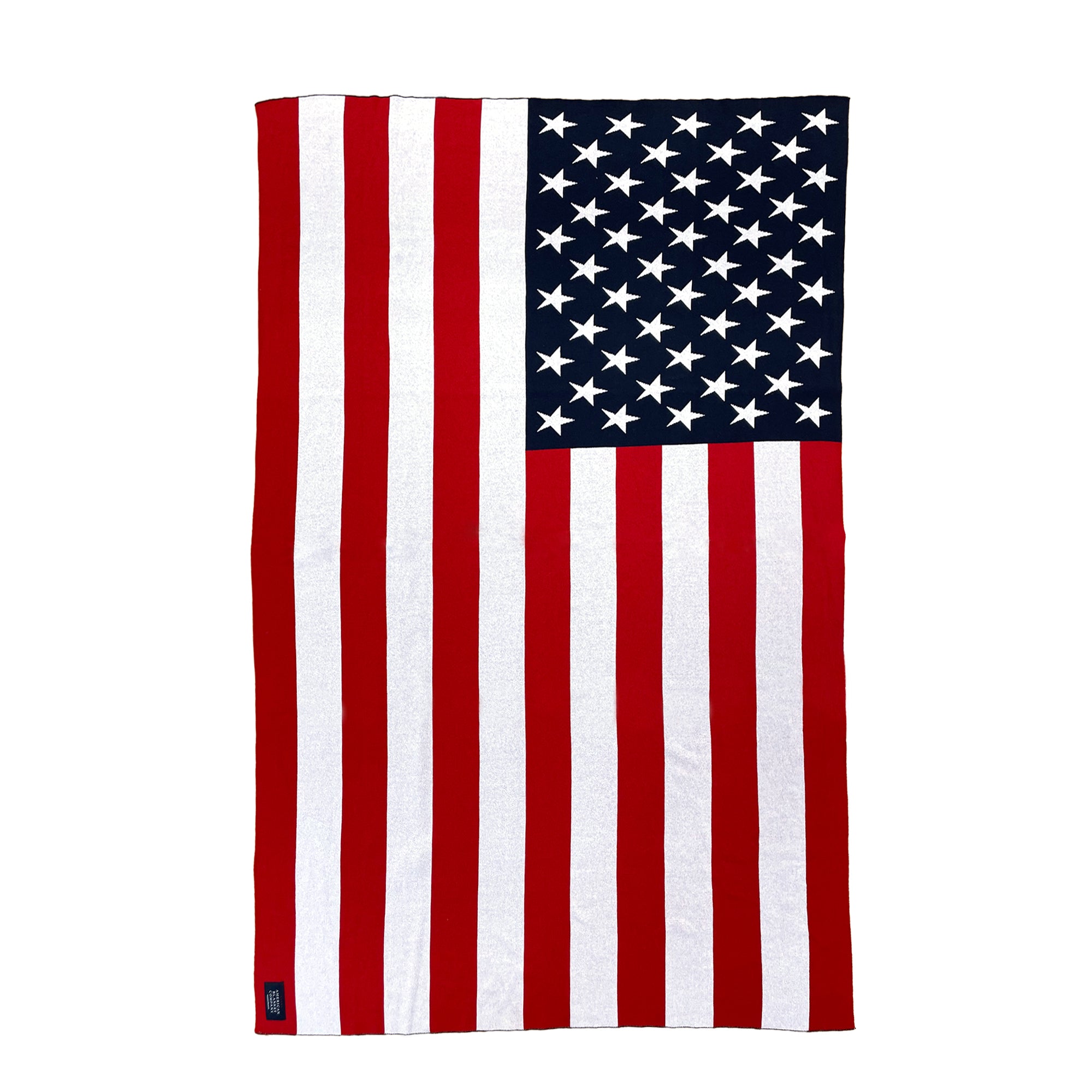 AMERICAN BLANKET COMPANY - KNITTED FLAG BLANKETS - Flat laid out blanket showing all stripes and American blanket company sew in tag in the lower left corner. 50% Cotton 50% polyester