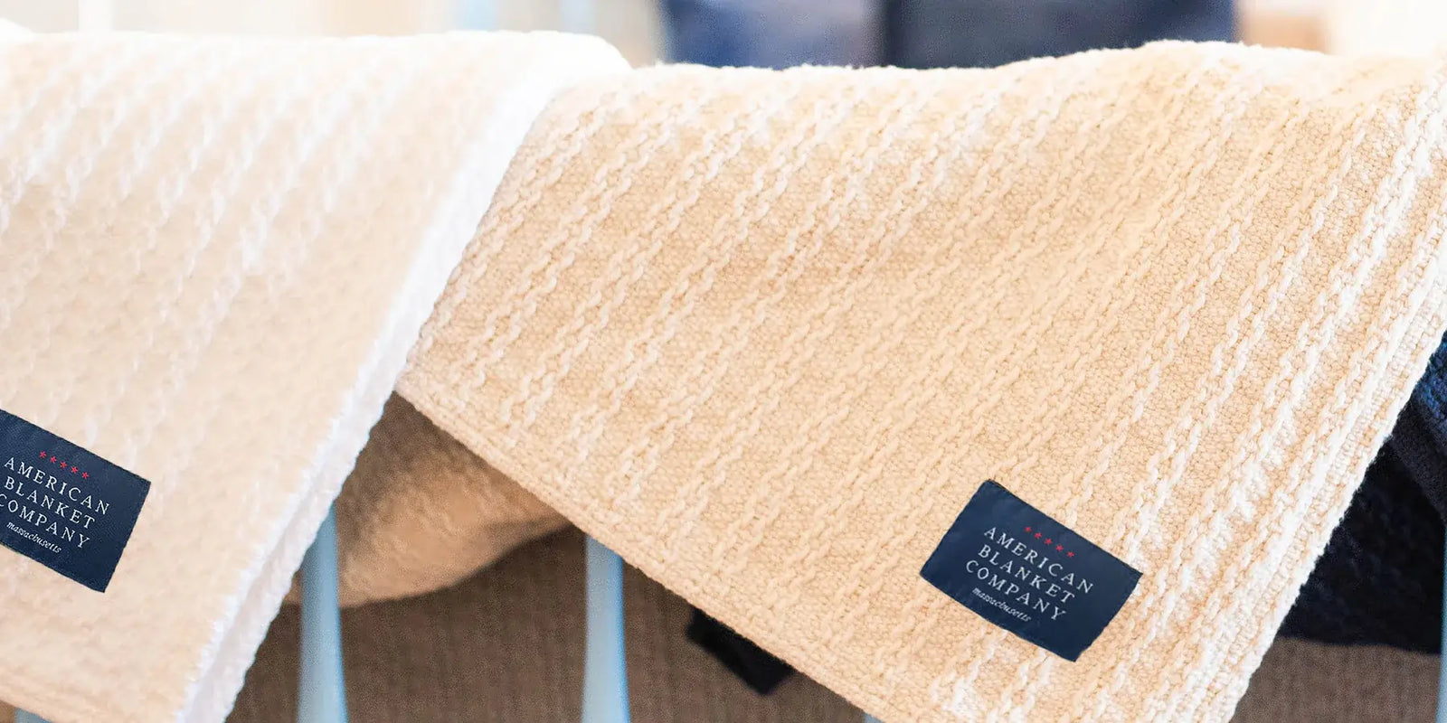 American Blanket Company - A close up of two 100% Cotton blankets with the american blanket company tag visible on the front.