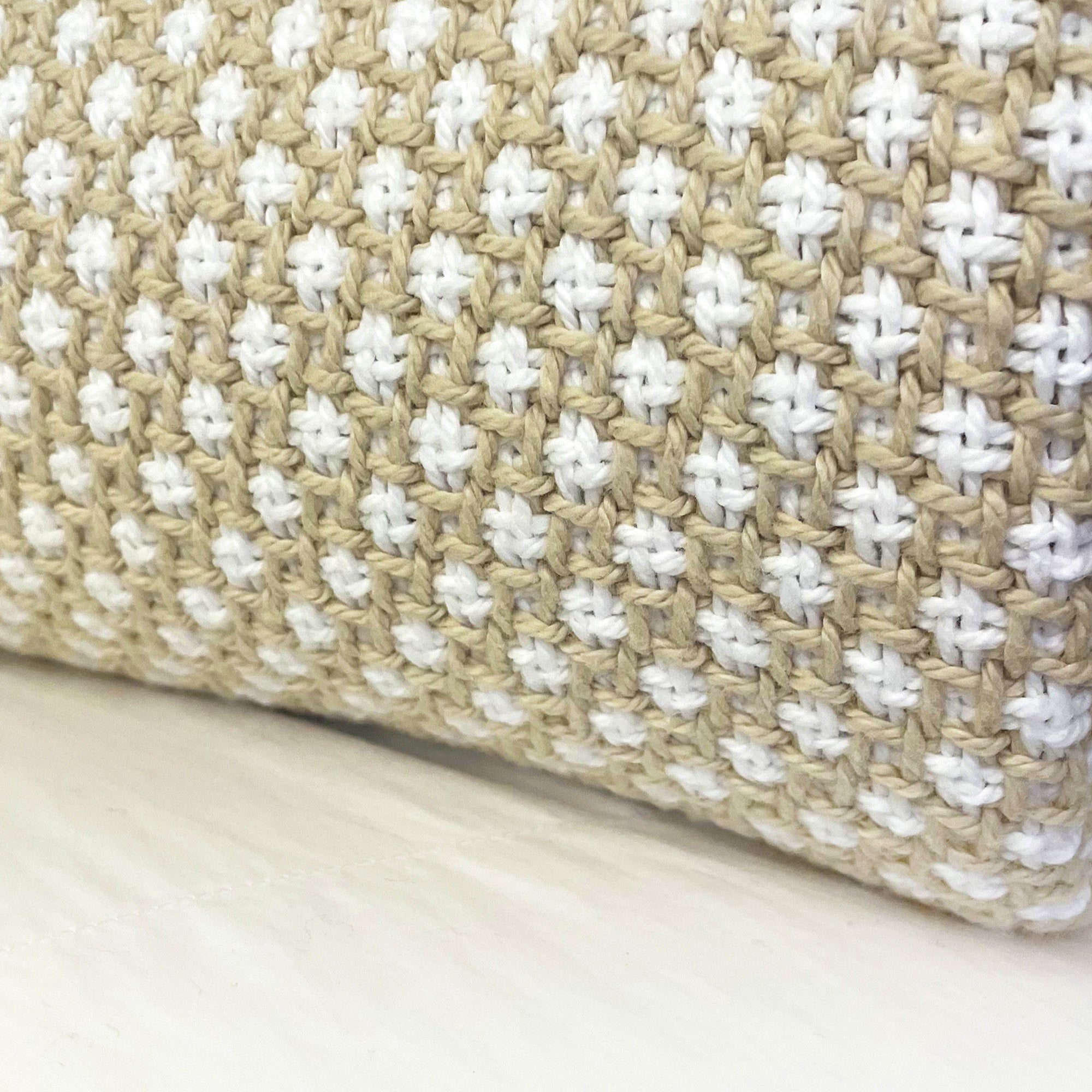 American Blanket Company - Cotton Blanket, 100% Cotton Lattice Weave cotton Blanket - Close up of the natural and white woven pattern, focusing on the rounded fold of the blanket.