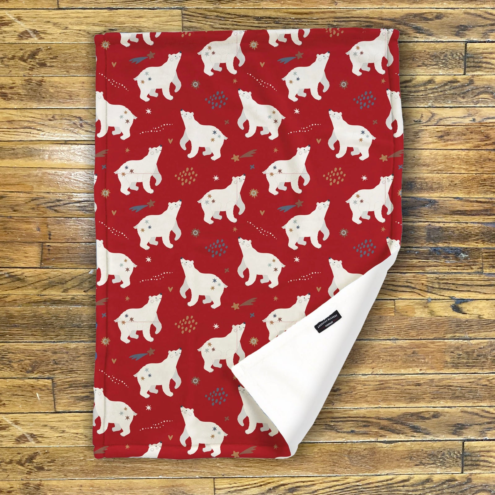 American Blanket Company - Luster Loft Fleece Blanket - Printed Holiday Patterned Throw Blanket - Fleece blanket red with white bear pattern on a wooden surface