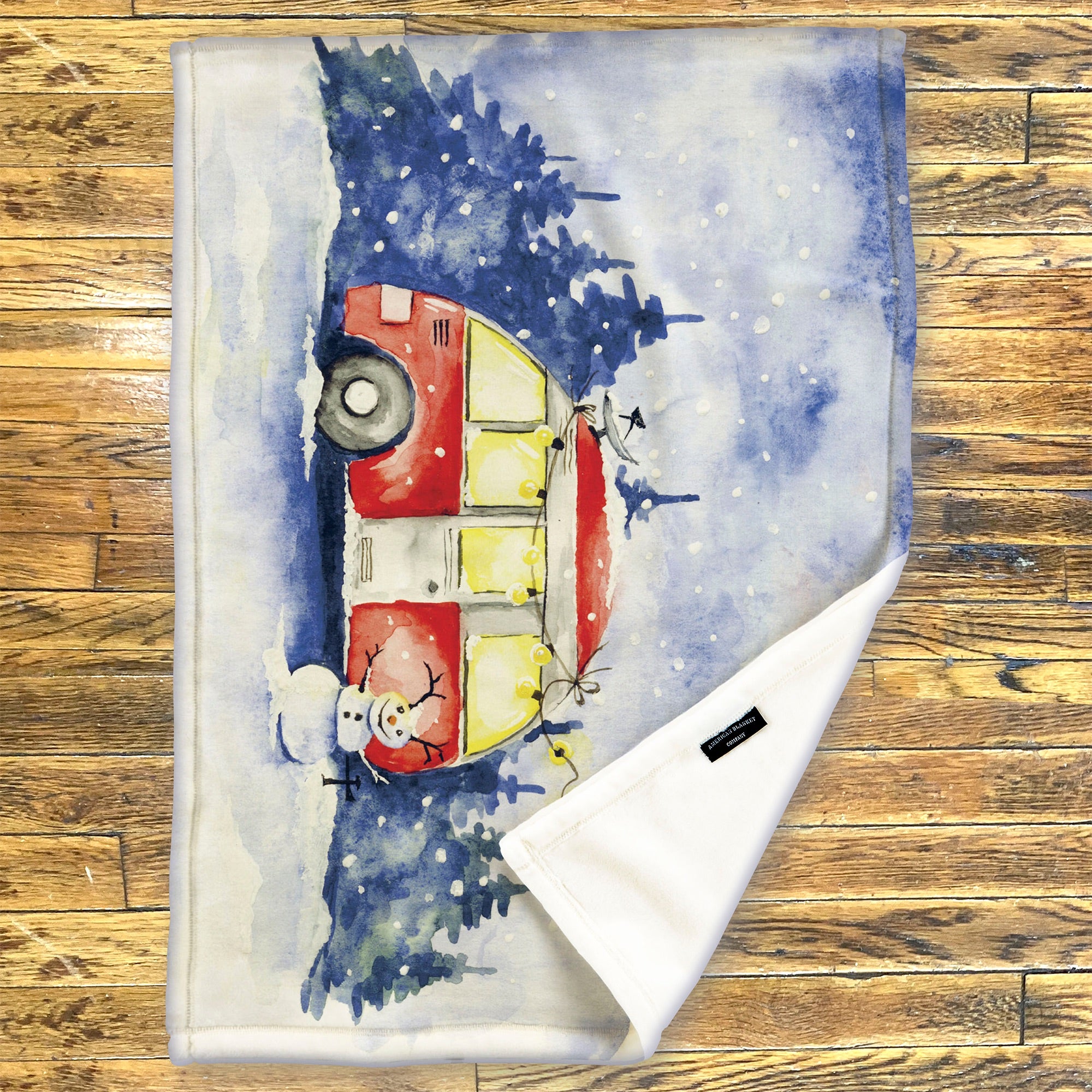 American Blanket Company - Luster Loft Fleece Blanket - Printed Holiday Throw Blanket - Fleece blanket with a winter scene featuring a red truck and snowman on a wooden surface.