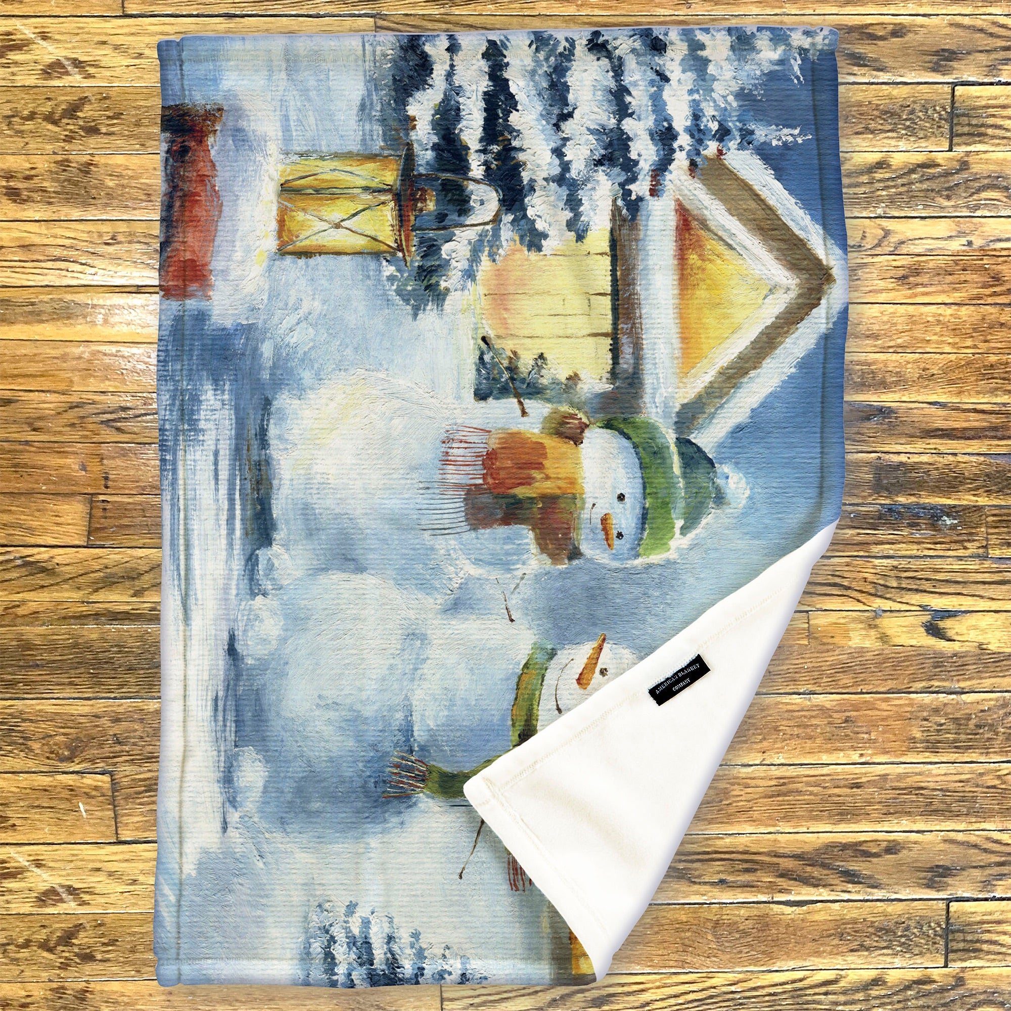 American Blanket Company - Luster Loft Fleece Blanket - Printed Holiday Throw Blanket -  Fleece blanket with a snowman design on a wooden surface