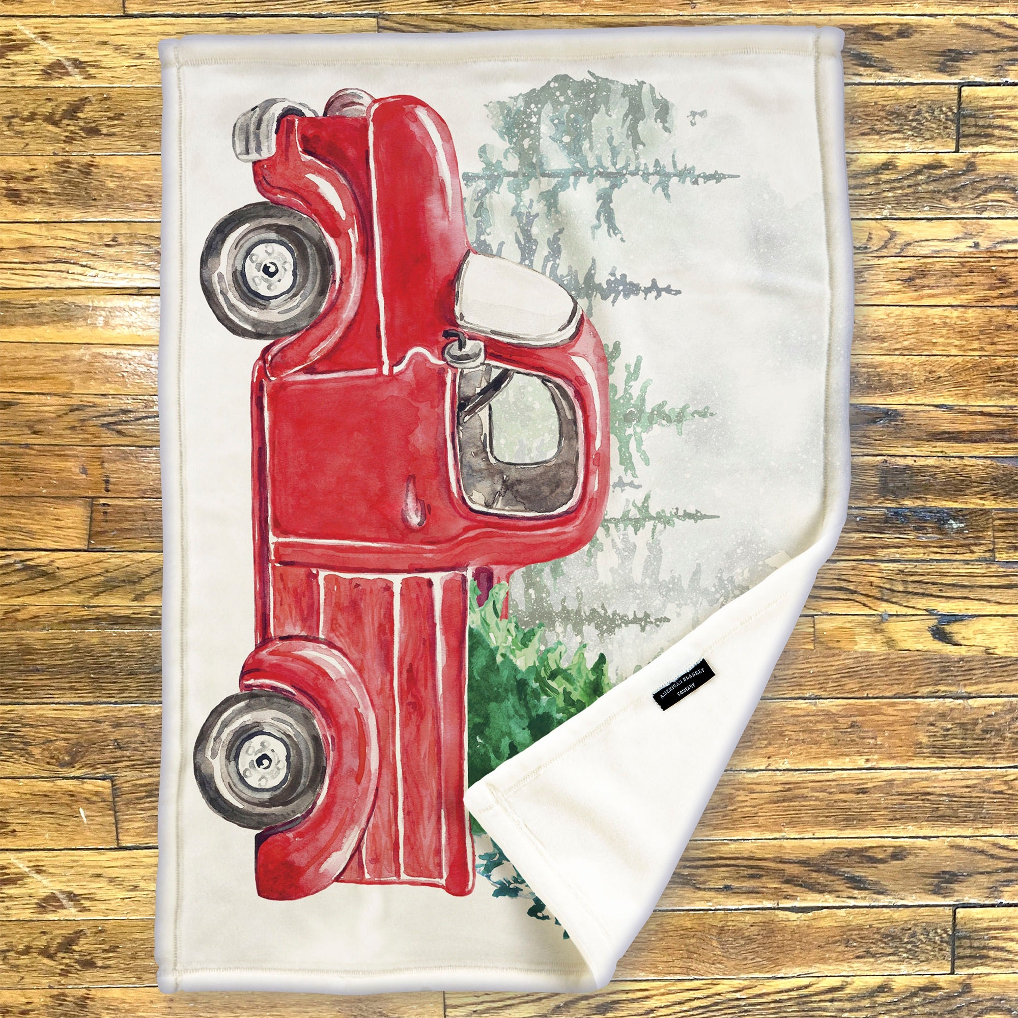 American Blanket Company - Luster Loft Fleece Blanket - Printed Holiday Throw Blanket - Fleece blanket with red truck design on a wooden surface