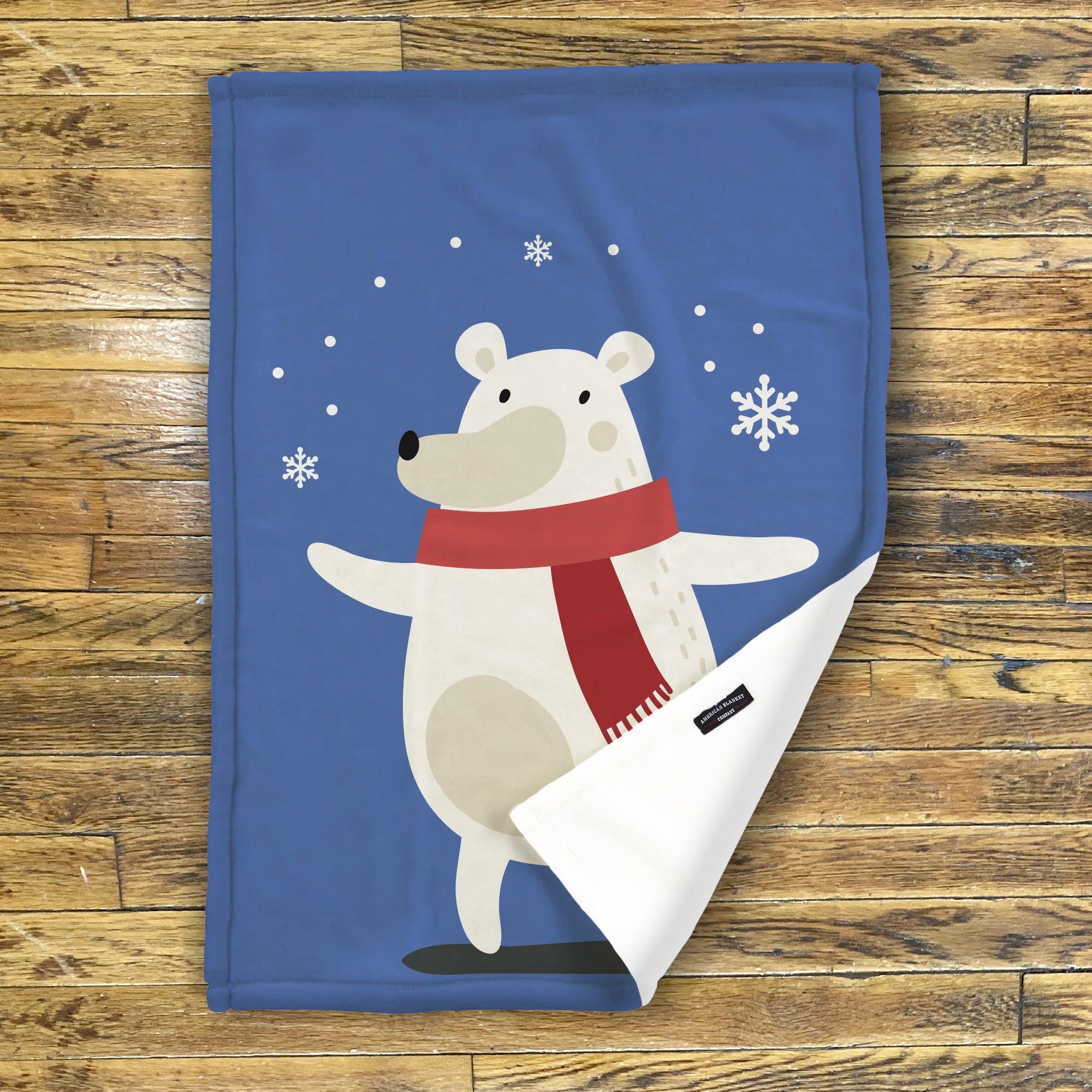 American Blanket Company - Luster Loft Fleece Blankets - Printed Holiday Critter Blankets - A festive blue fleece throw blanket featuring a white polar bear wearing a red scarf, with snowflake decorations and a personalizable name space.