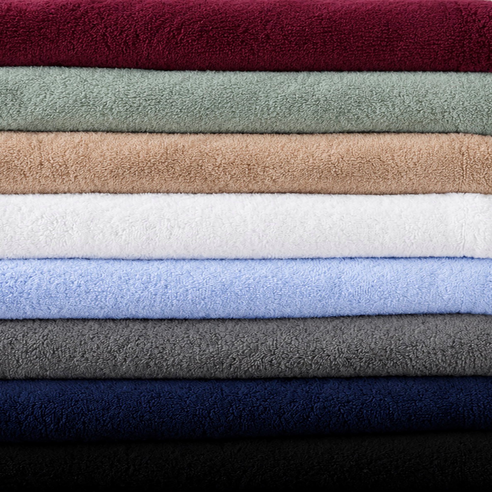 USA made towels stacked on top of each other showing all available colors, Burgundy, Sage green, Sand, White, Light Blue, Charcoal, Navy, Black