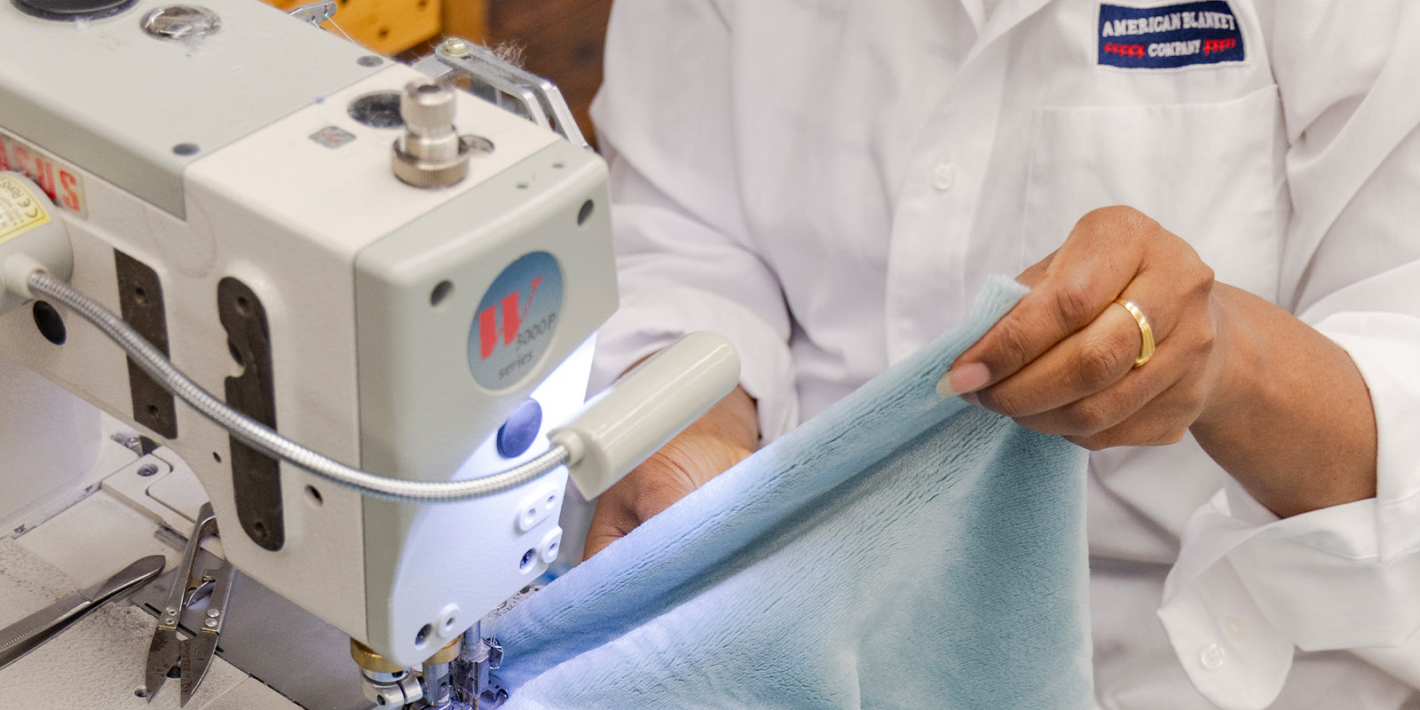 American Blanket Company - Person using a sewing machine to work on a luster loft fleece blanket