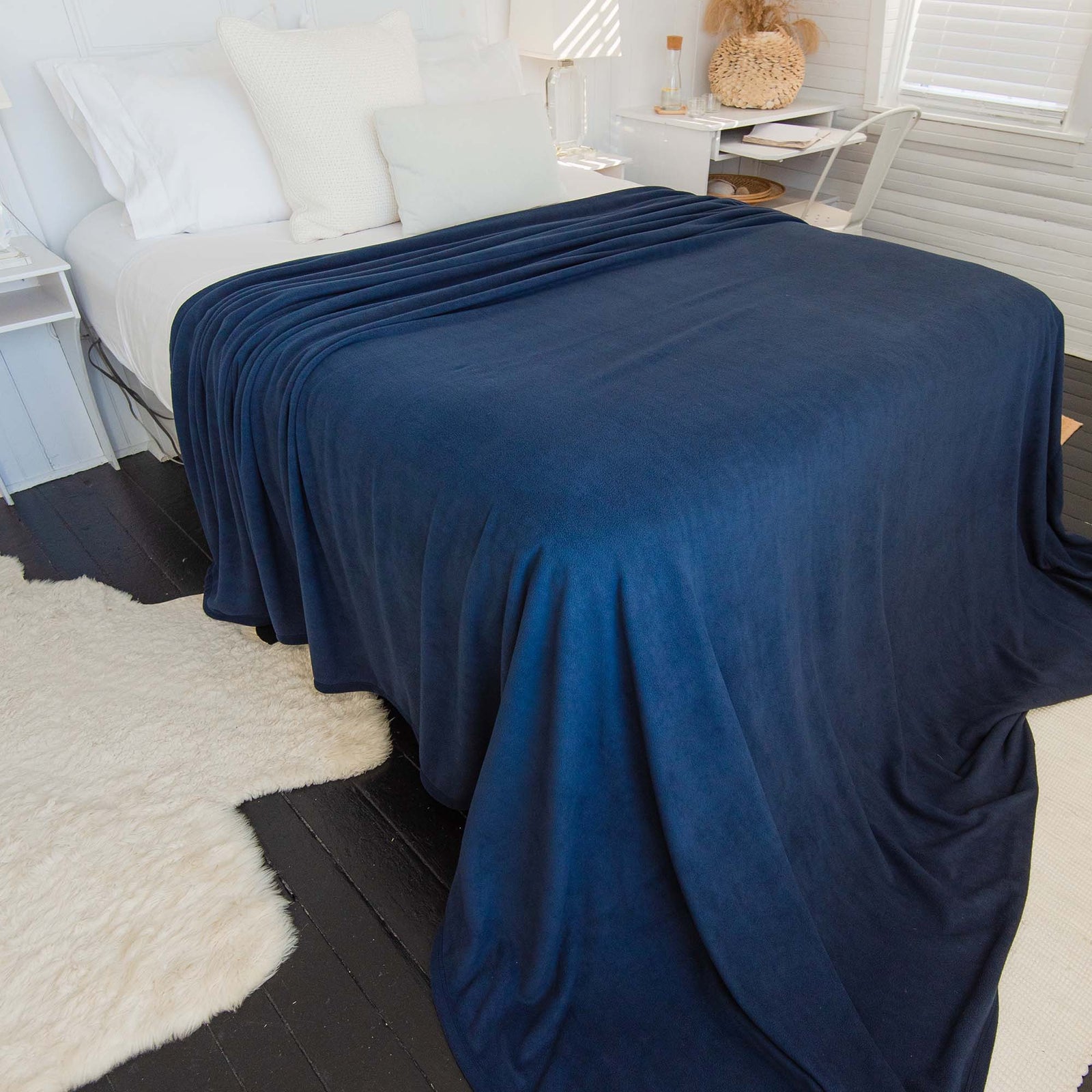 American Blanket Company - Peaceful Touch Biggest, Oversized, Fleece Blankets - Blue peaceful touch oversized blanket on top of a queen bed, flowing over onto the floor