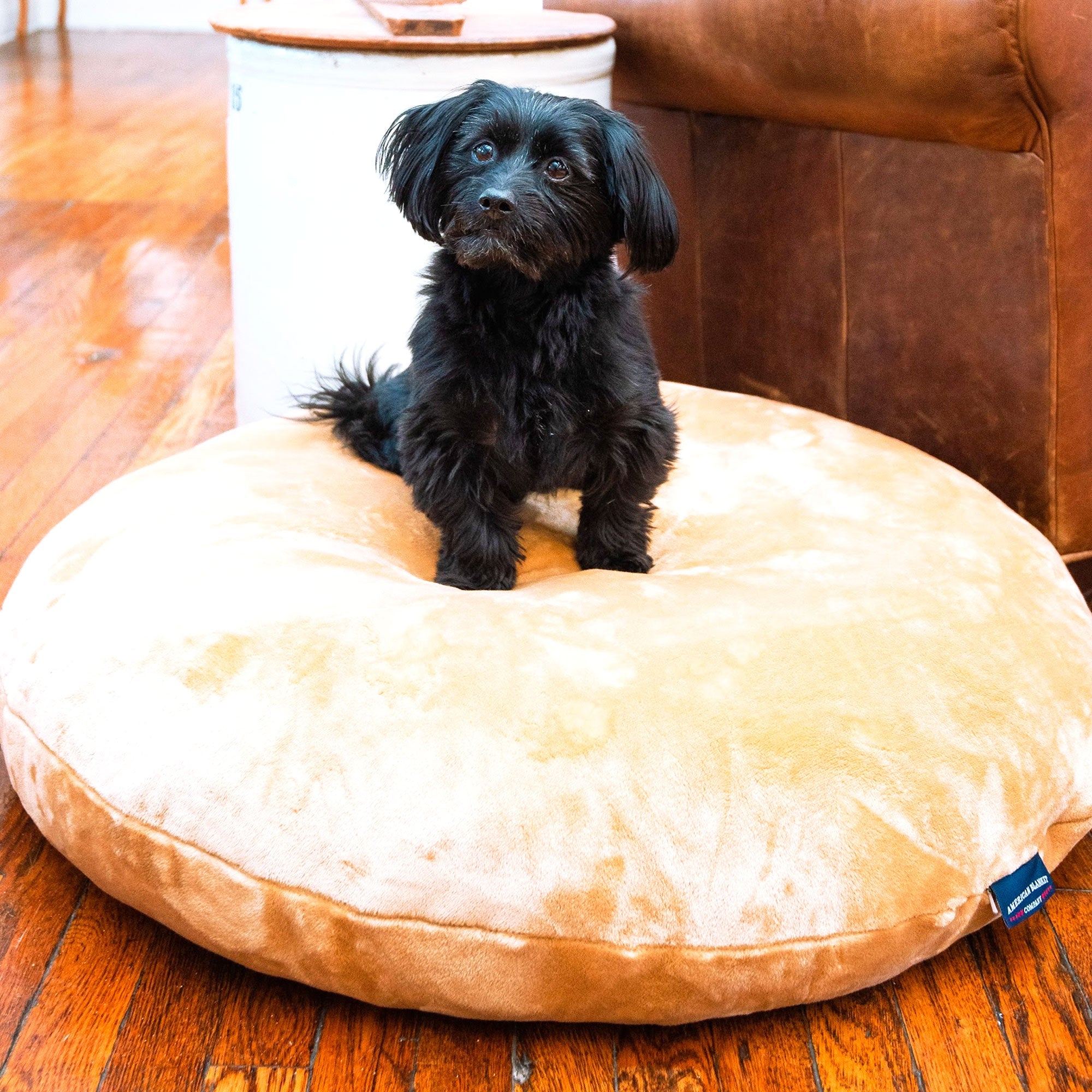American Blanket Company - Luster Loft Fleece Pet Bed - a small black dog sitting on top of a Luxurious brown fleece dog bed.