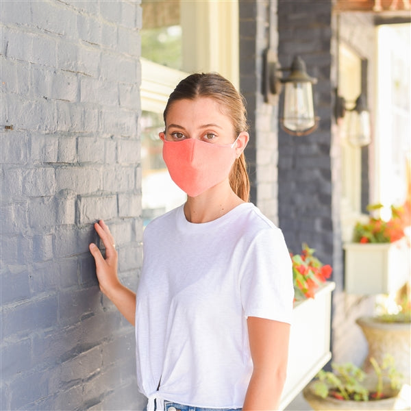 American Blanket Company - Peaceful touch fleece face mask - woman wearing a pink colored fleece face mask