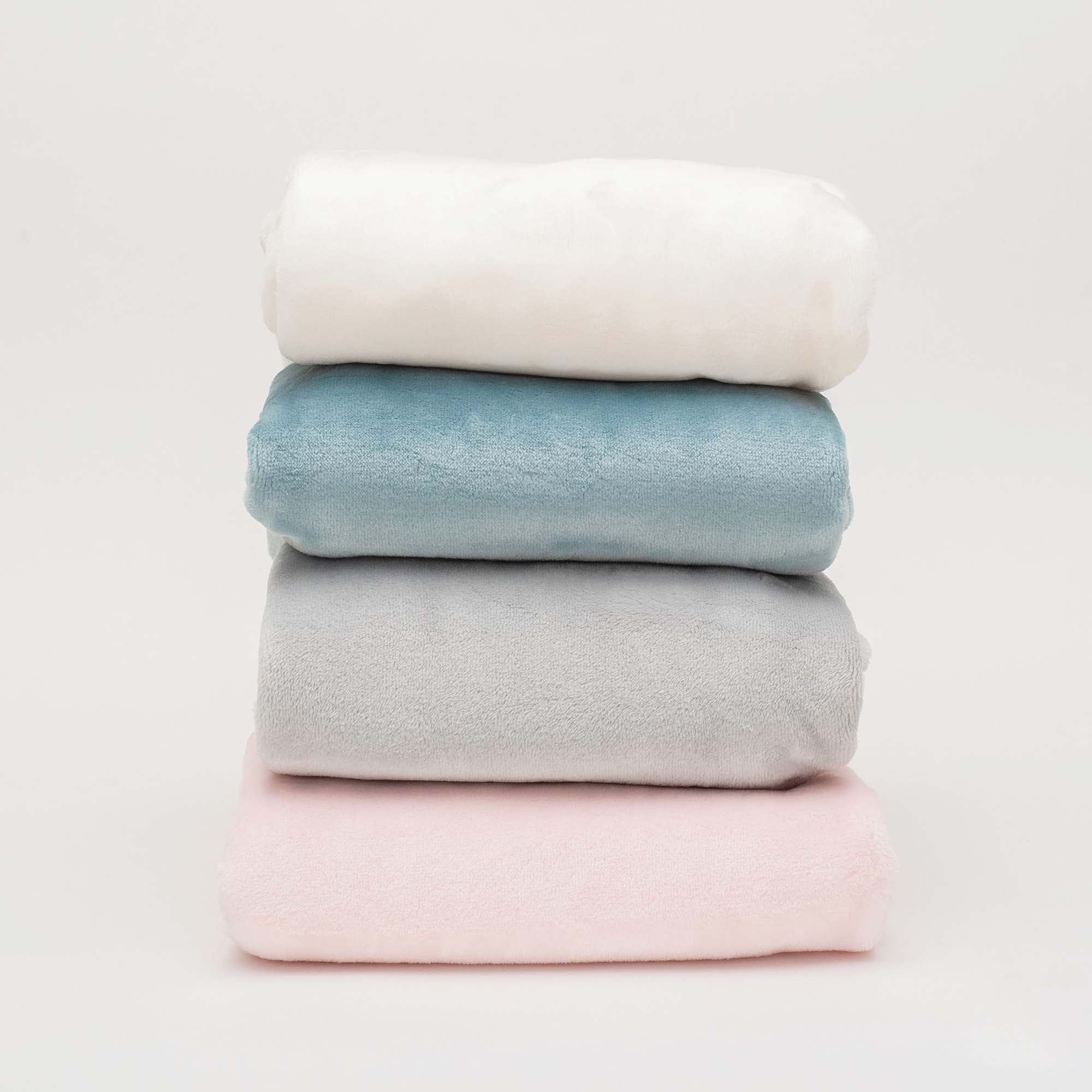 American Blanket Company - Luster Loft Whip Stitched Fleece Baby Blankets - Stack of fleece whip stitched baby blankets - light blue, gray, cream, and pink.