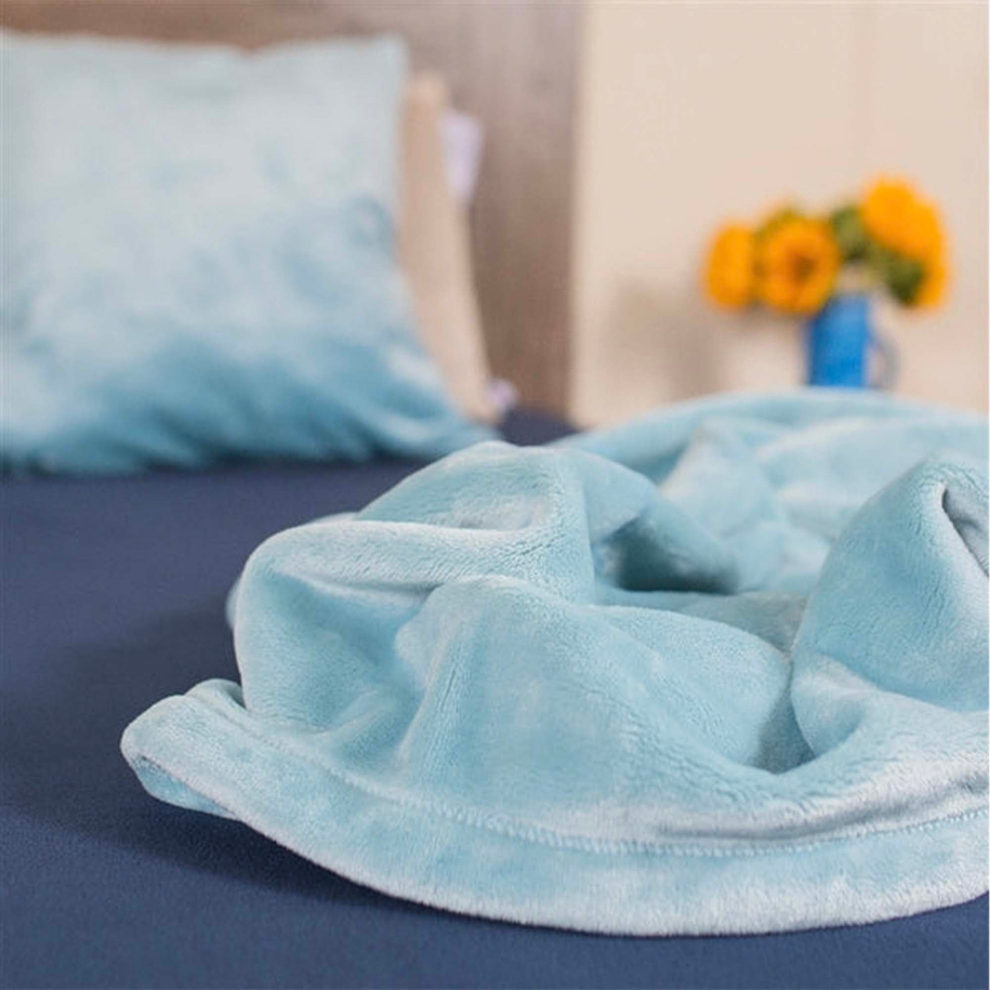 American Blanket Company - Blue Luster Loft  Fleece Blanket & Fleece Pillowcase -Set a matching fleece pillow case on a wooden surface.