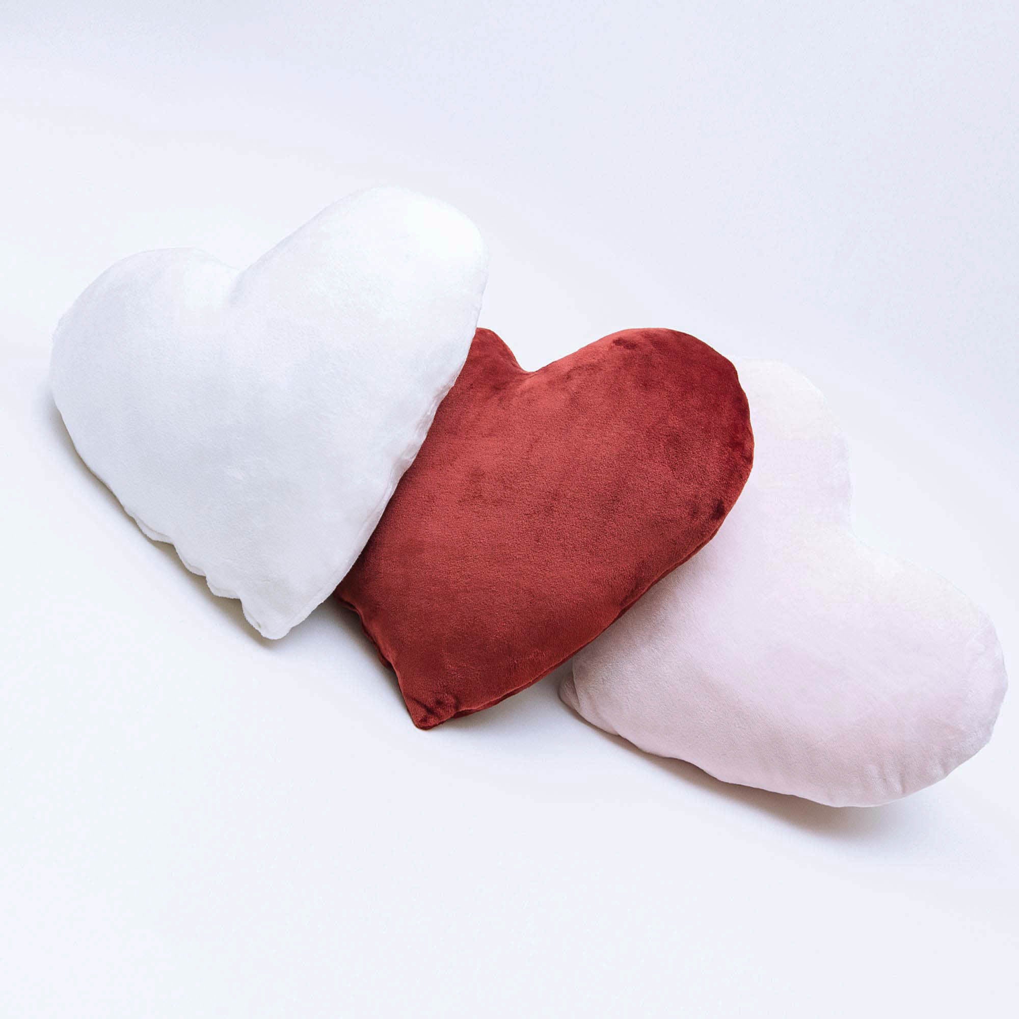 American Blanket Company - luster loft fleece heart pillows - Trio Of Luster Loft Fleece heart pillows in white, red, and pale pink