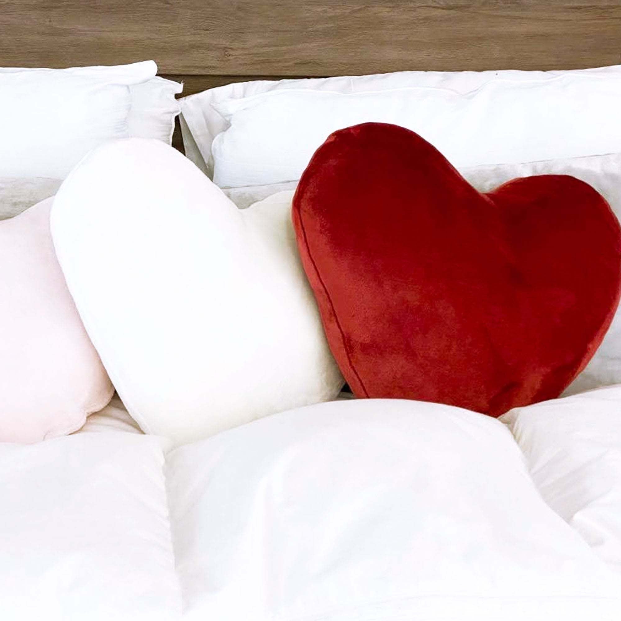 American Blanket Company - luster loft fleece heart pillows - trio of fleece heart pillows on bed 