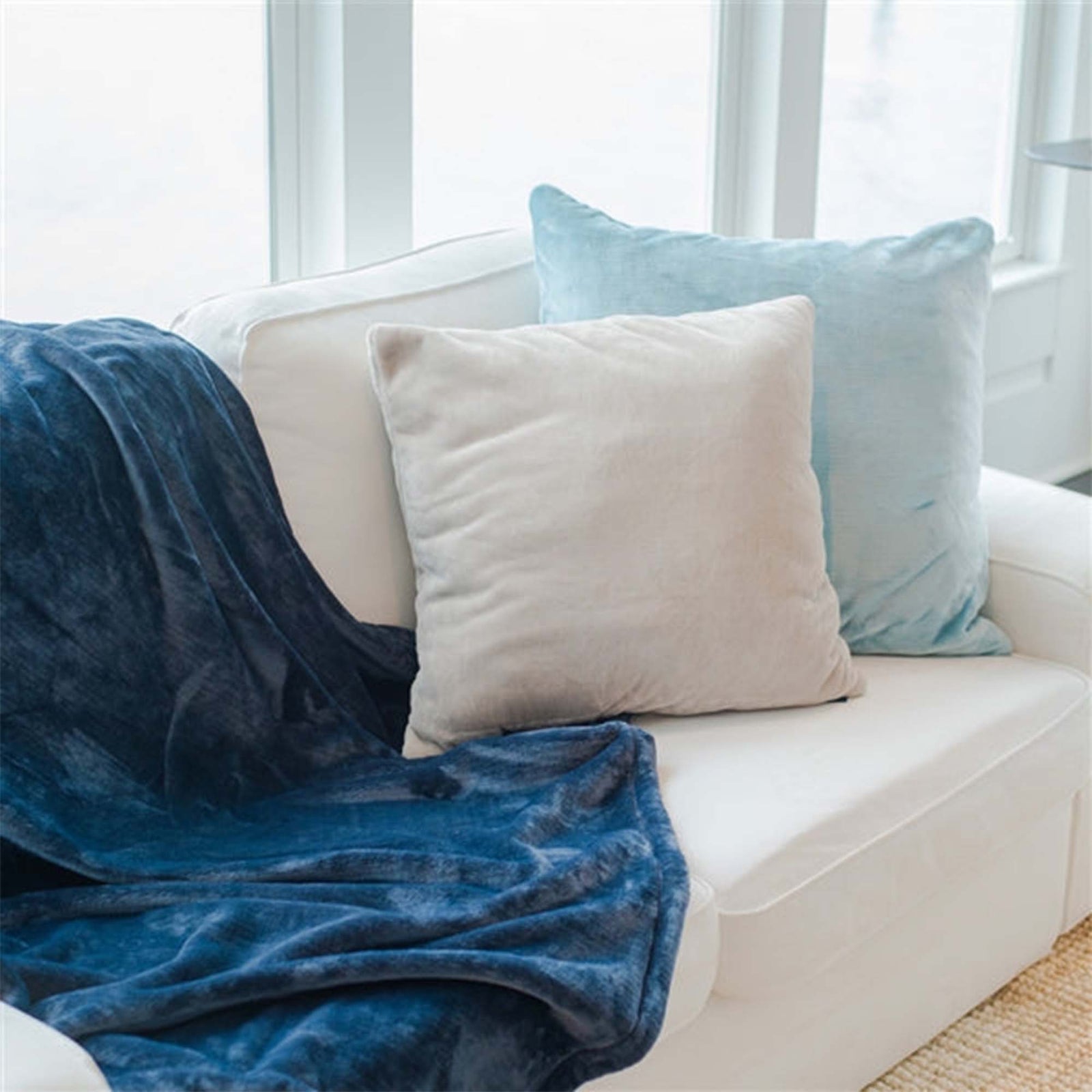 American Blanket Company -  luster loft fleece throw pillows - White and blue throw pillows on white couch - Luster Loft