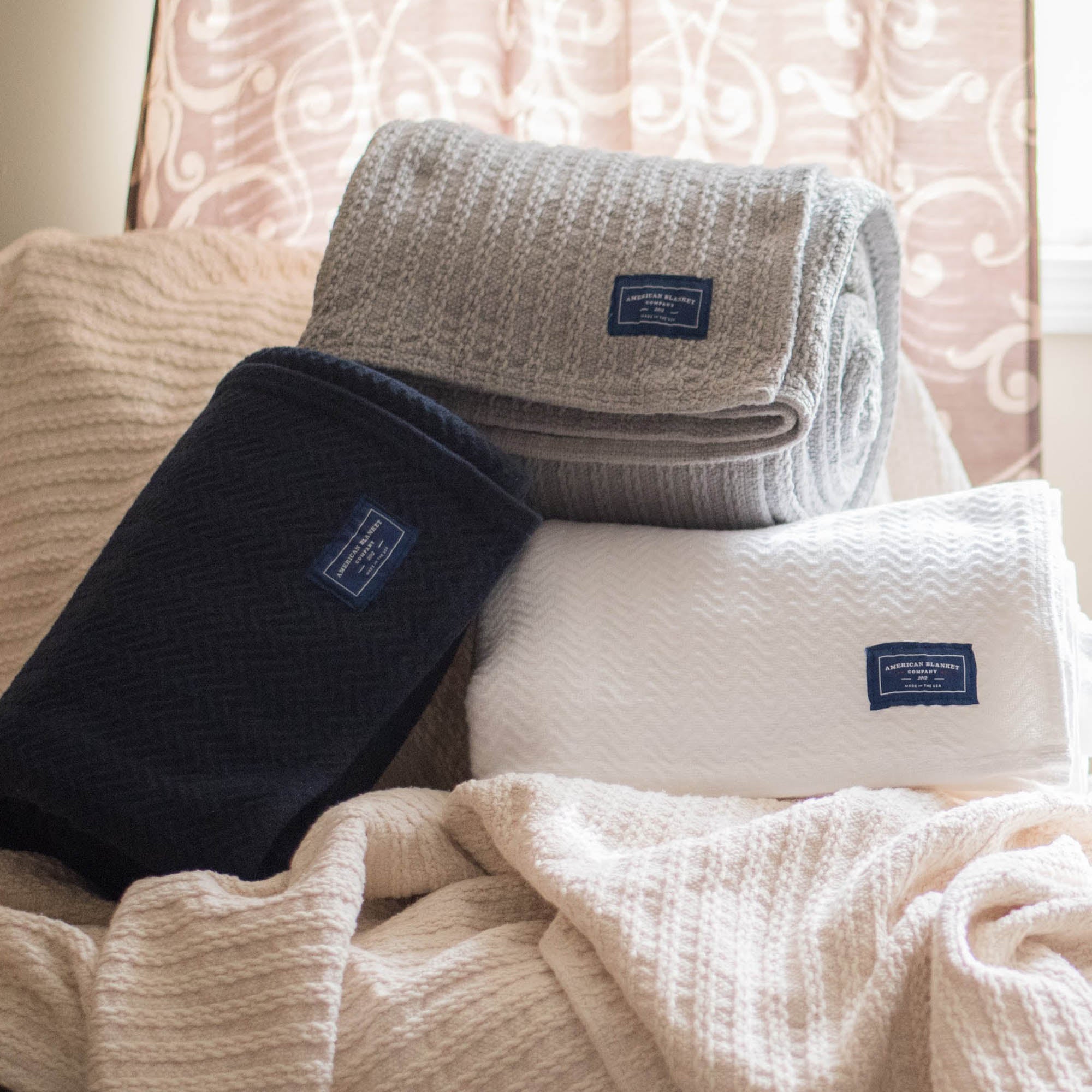 American Blanket Company - Oversized Cable weave 100% Cotton Blanket - Multiple rolled cotton blankets on a larger cotton blanket