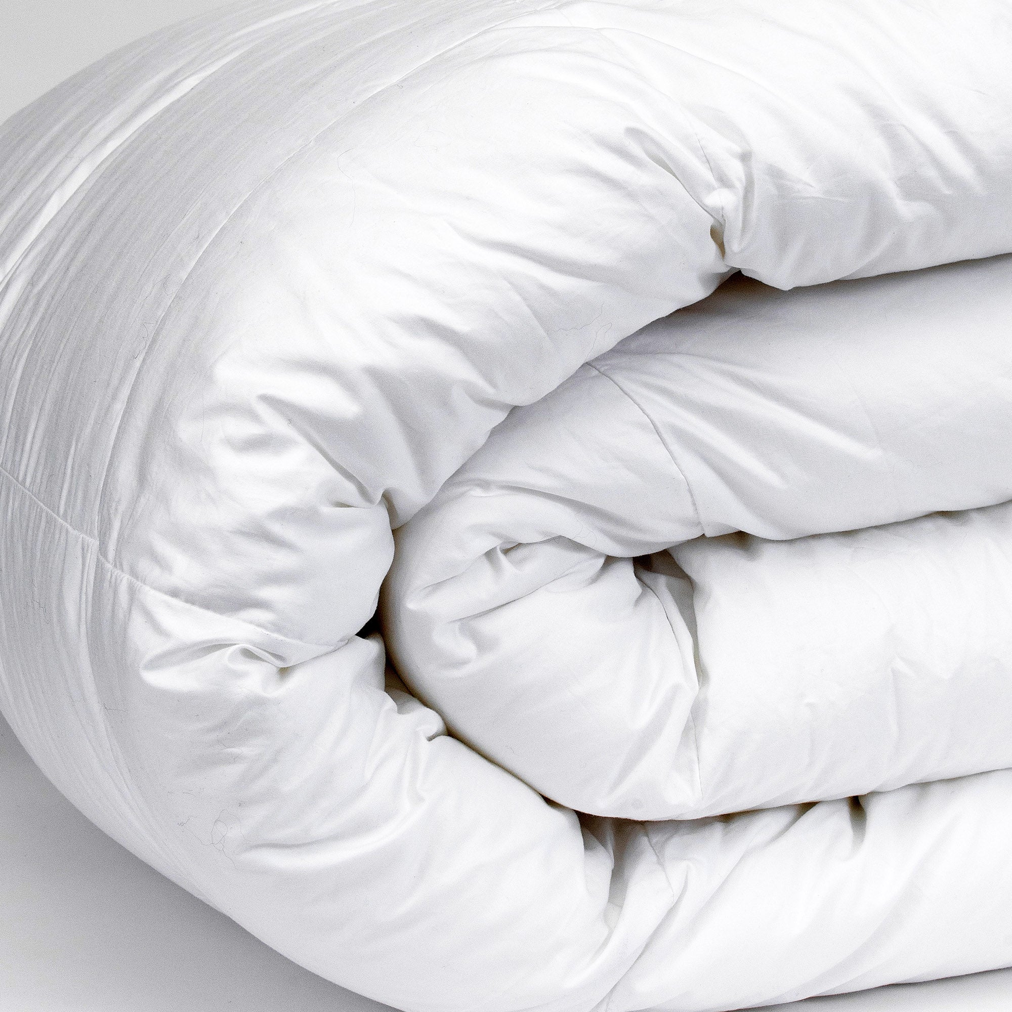 American Blanket Company - Down Comforter Heavy Weight - Side view folded fluffy white down heavy weight comforter