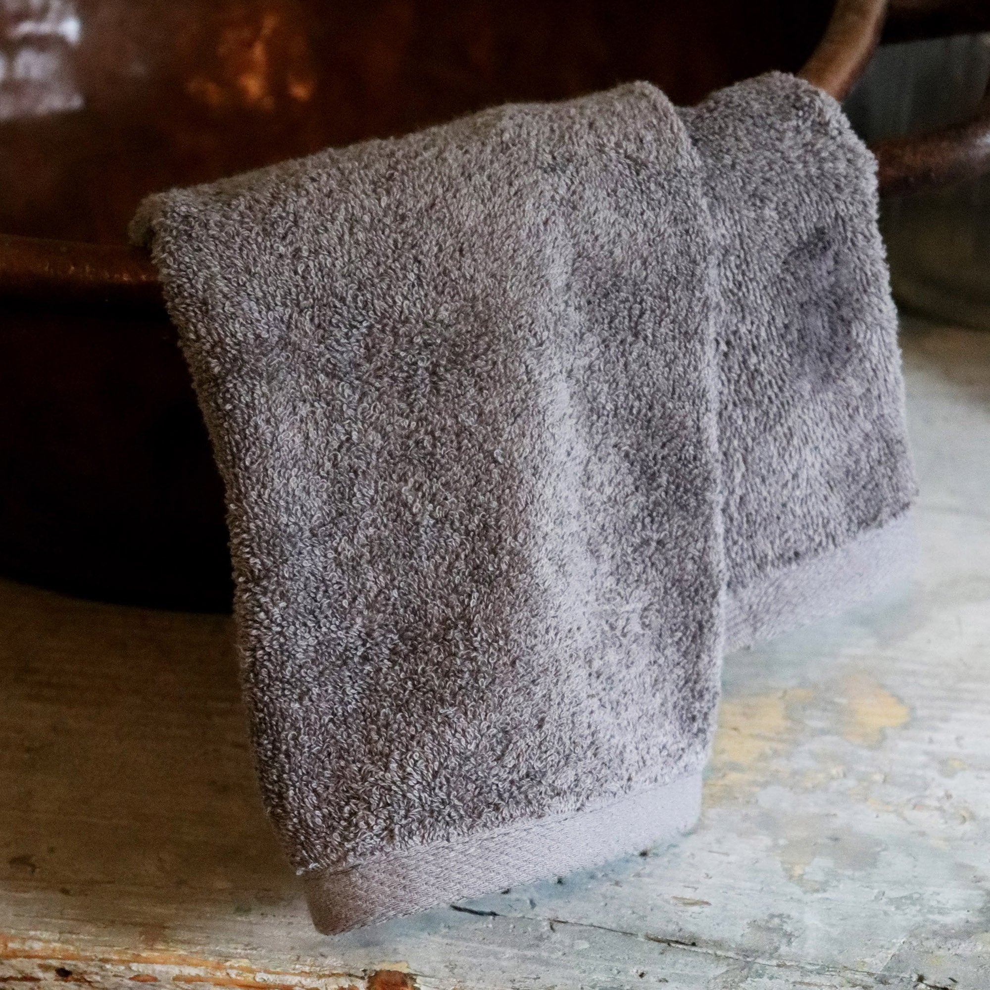 American Blanket Company -  Colorful 100% Cotton Towels - Gray Cotton hand towel draped over a basin
